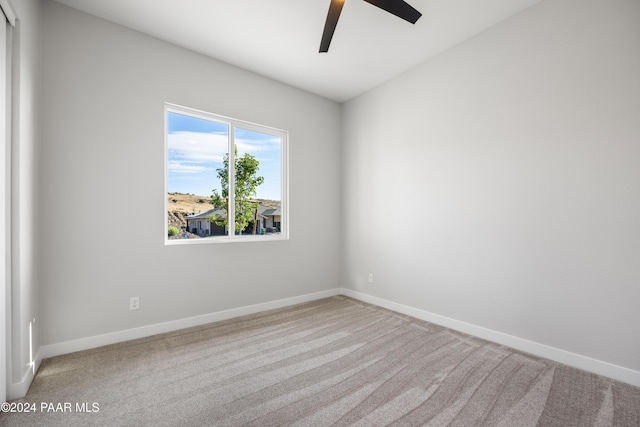 unfurnished bedroom with light carpet, a closet, and ceiling fan