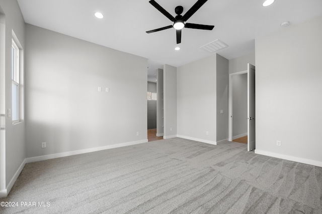 living room featuring ceiling fan, a large fireplace, and dark wood-type flooring