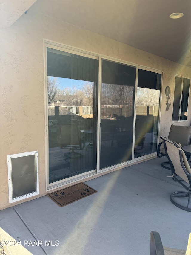 view of exterior entry featuring a patio