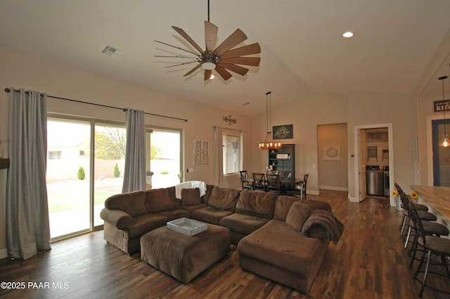 8737 N Mare St, Prescott Valley, AZ 86315 - living area featuring a chandelier, dark wood-style flooring, vaulted ceiling, baseboards, and washer and dryer