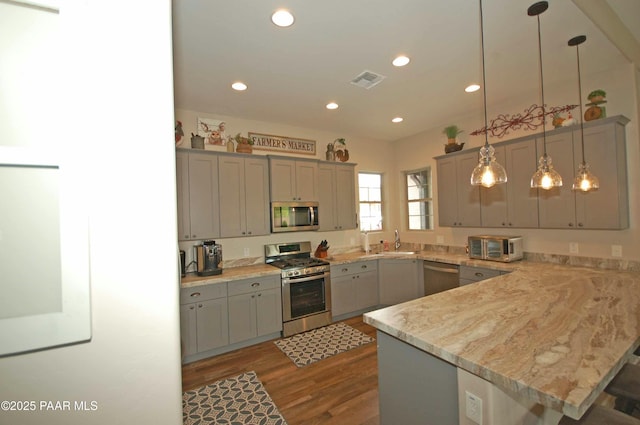 8737 N Mare St, Prescott Valley, AZ 86315 - kitchen featuring stainless steel appliances, a sink, a peninsula, wood finished floors, and light countertops