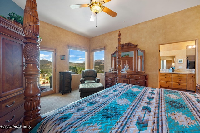 bedroom with ceiling fan, carpet floors, and connected bathroom