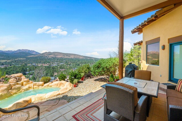 view of patio / terrace featuring a mountain view