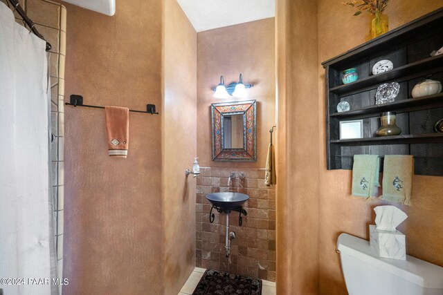 bathroom featuring tile patterned floors, toilet, and sink