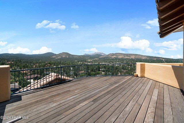 wooden deck with a mountain view