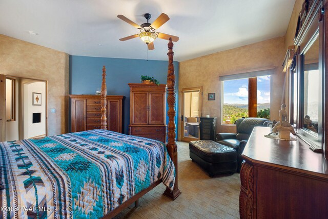 bedroom with light carpet and ceiling fan