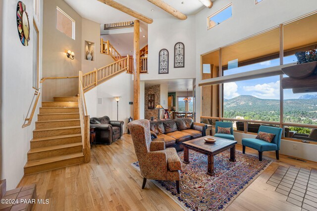 living room with a mountain view, light hardwood / wood-style floors, and plenty of natural light