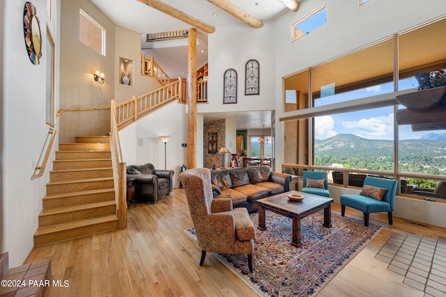 2253 Shadow Ridge Rd, Prescott, AZ 86305 - living room with hardwood / wood-style floors, a towering ceiling, stairway, a mountain view, and beamed ceiling