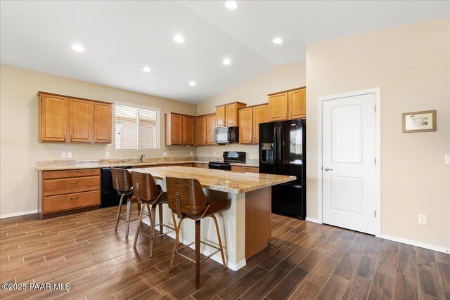 1364 Towhee Trl, Prescott, AZ 86305 - kitchen with black appliances, lofted ceiling, dark wood-type flooring, a center island, and a kitchen breakfast bar