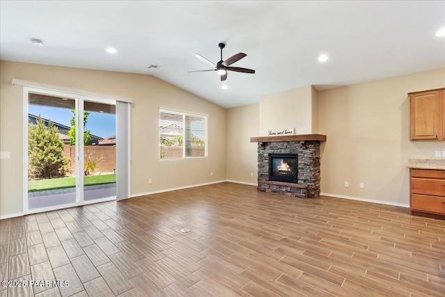 1364 Towhee Trl, Prescott, AZ 86305 - unfurnished living room with ceiling fan, light wood finished floors, lofted ceiling, a stone fireplace, and baseboards