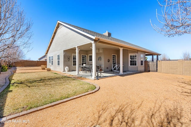 rear view of property with a patio area and a lawn