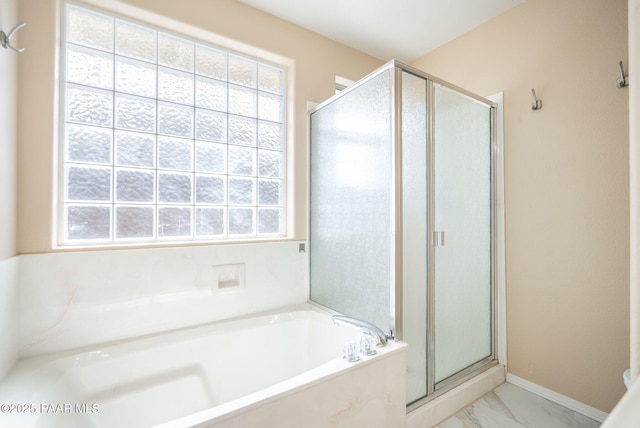 bathroom with a bath, baseboards, a stall shower, and marble finish floor