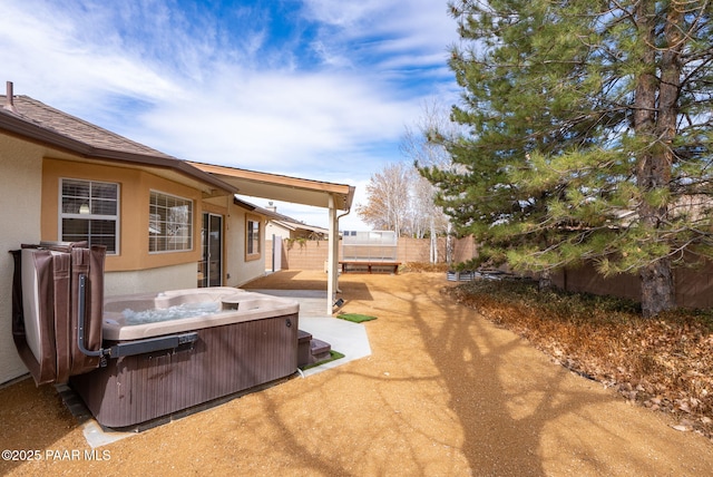 view of yard with a patio, a hot tub, and a fenced backyard