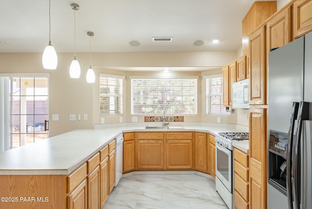 kitchen featuring a wealth of natural light, visible vents, white appliances, and marble finish floor