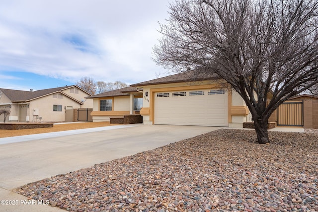 view of front facade with stucco siding, concrete driveway, and an attached garage