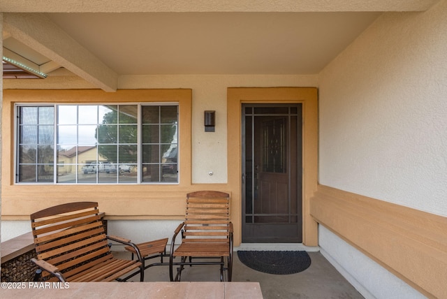 view of exterior entry with stucco siding