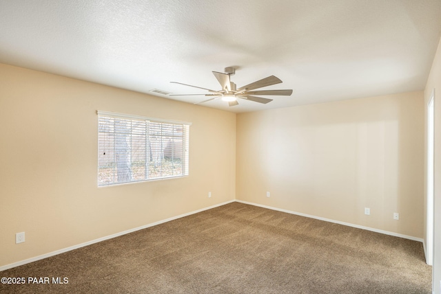 spare room featuring visible vents, baseboards, carpet, and a ceiling fan