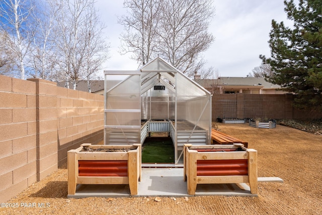 exterior space with an outbuilding, a fenced backyard, and an exterior structure