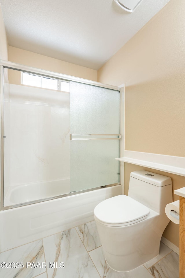 full bathroom featuring enclosed tub / shower combo, toilet, marble finish floor, and vanity