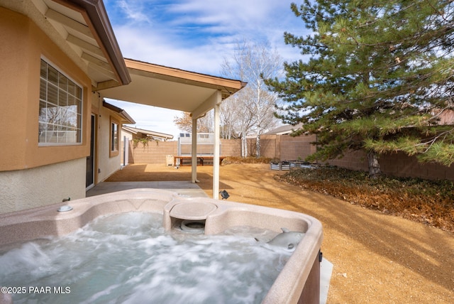 view of patio / terrace featuring a fenced backyard and a hot tub