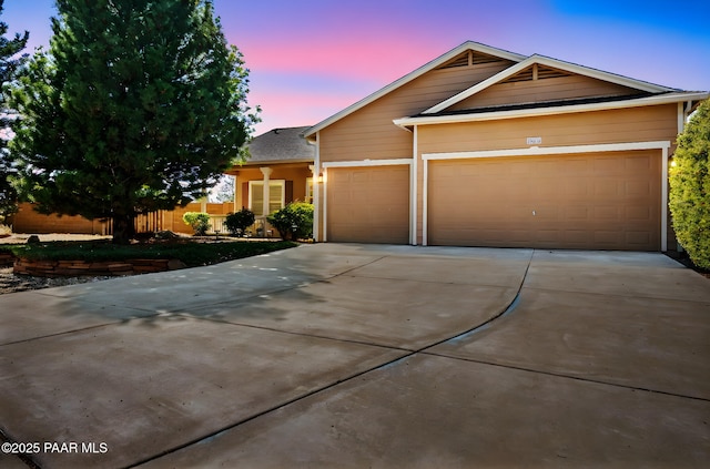 7876 N Siesta Sunset Ln, Prescott Valley, AZ 86315 - view of front facade featuring fence, an attached garage, and concrete driveway