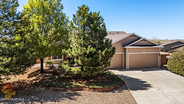 7876 N Siesta Sunset Ln, Prescott Valley, AZ 86315 - view of front facade with an attached garage, a shingled roof, and driveway