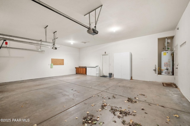 7876 N Siesta Sunset Ln, Prescott Valley, AZ 86315 - garage featuring a garage door opener and gas water heater