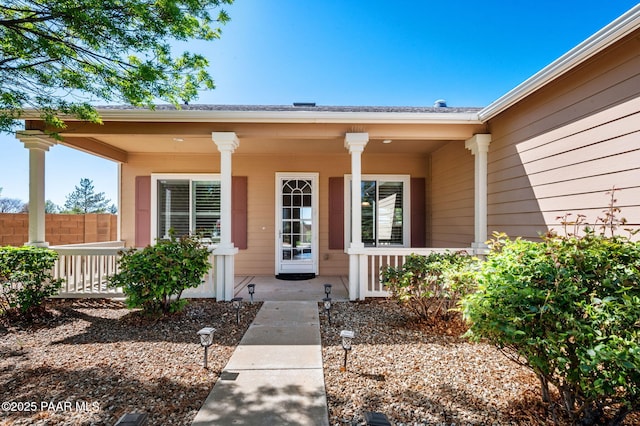 7876 N Siesta Sunset Ln, Prescott Valley, AZ 86315 - view of exterior entry featuring a porch and fence