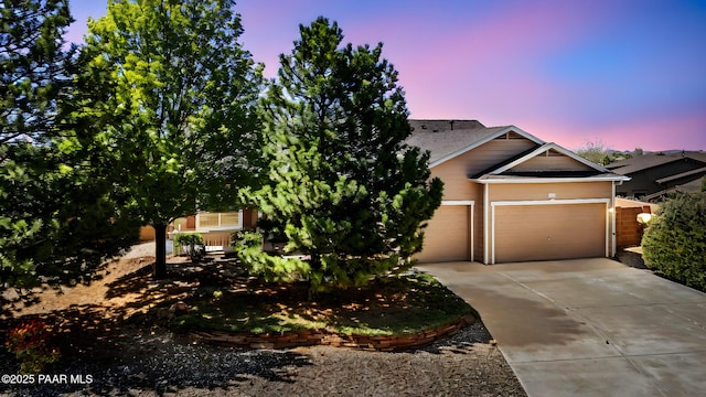 7876 N Siesta Sunset Ln, Prescott Valley, AZ 86315 - obstructed view of property featuring an attached garage and concrete driveway