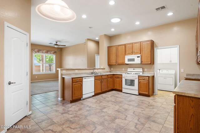 7876 N Siesta Sunset Ln, Prescott Valley, AZ 86315 - kitchen with visible vents, washer / dryer, a peninsula, white appliances, and a sink
