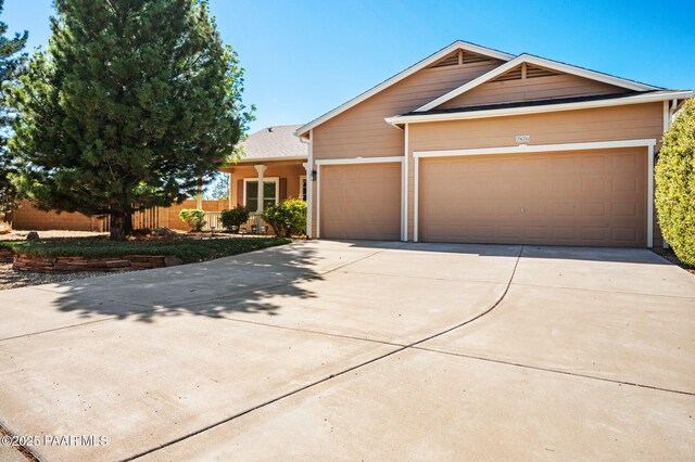 7876 N Siesta Sunset Ln, Prescott Valley, AZ 86315 - view of front of property with fence, an attached garage, and concrete driveway