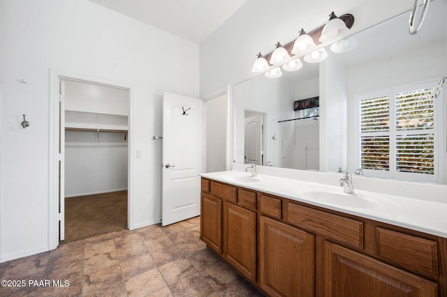 7876 N Siesta Sunset Ln, Prescott Valley, AZ 86315 - bathroom with double vanity, a sink, baseboards, and stone finish floor