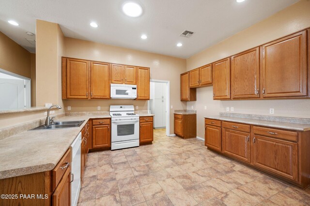 7876 N Siesta Sunset Ln, Prescott Valley, AZ 86315 - kitchen featuring a sink, brown cabinets, and white appliances