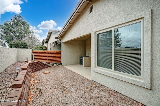 view of property exterior featuring a fenced backyard and stucco siding