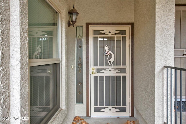 property entrance with stucco siding