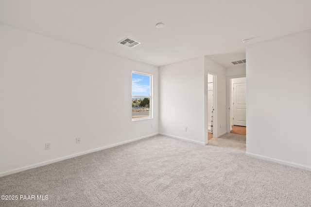 unfurnished room with light carpet