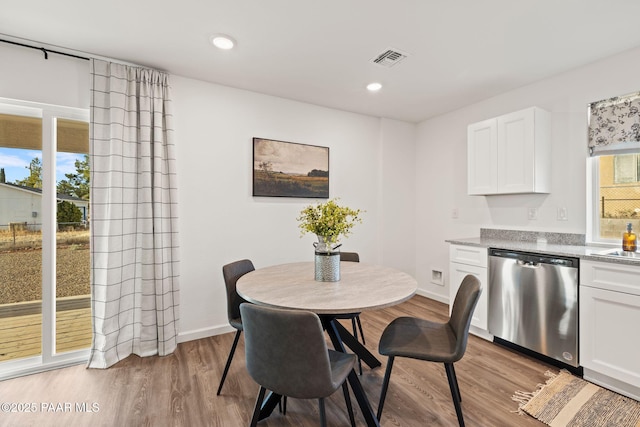 dining room featuring sink and light hardwood / wood-style flooring