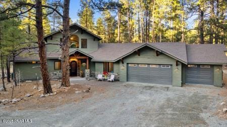 rustic home with dirt driveway and an attached garage