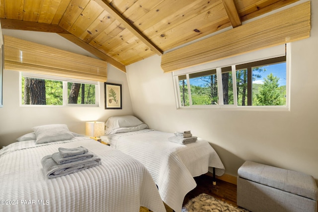 bedroom with wooden ceiling, vaulted ceiling with beams, baseboards, and wood finished floors
