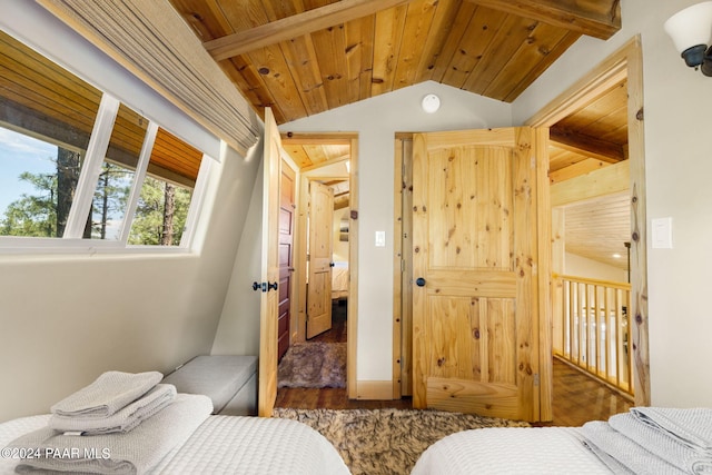 bedroom with wood ceiling, vaulted ceiling with beams, and wood finished floors