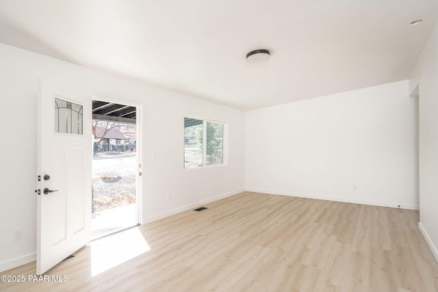 unfurnished room with light wood-type flooring