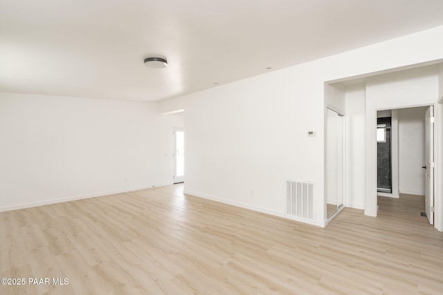 spare room with light hardwood / wood-style flooring and a healthy amount of sunlight