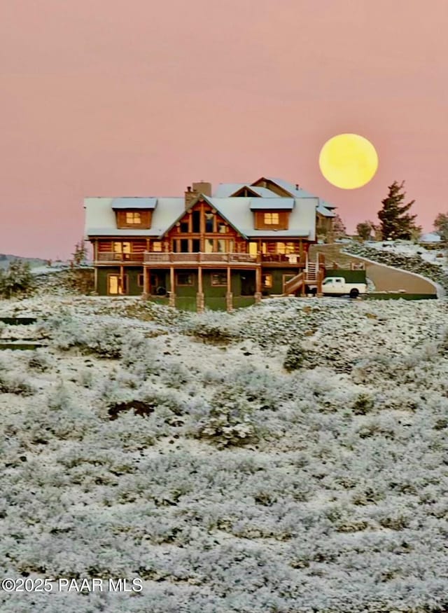 view of snow covered rear of property