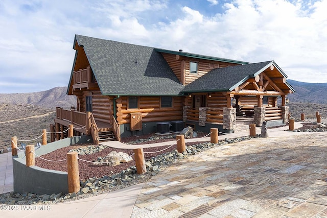 log cabin featuring a mountain view and central air condition unit