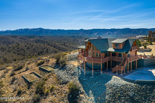 back of house with a deck with mountain view