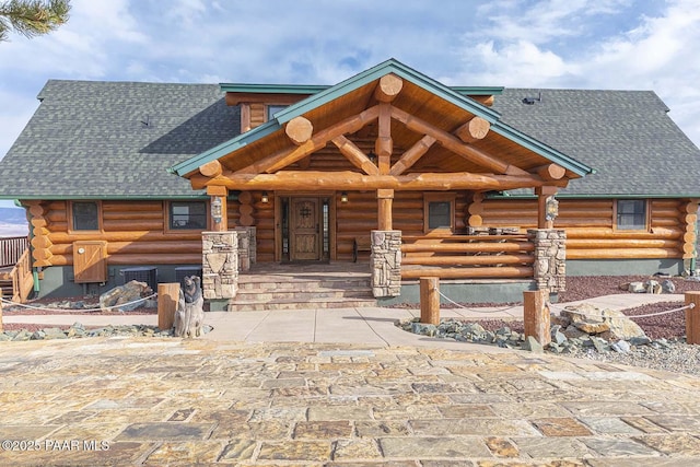 log-style house featuring a porch