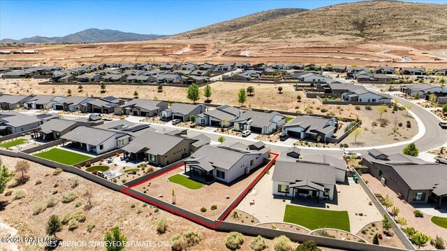 drone / aerial view featuring a residential view and a mountain view