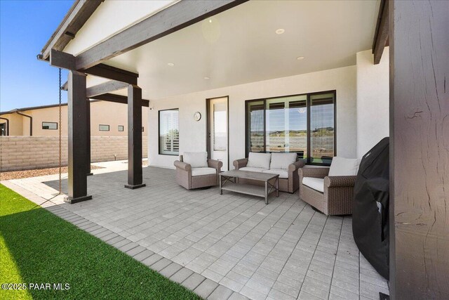 view of patio with fence and outdoor lounge area
