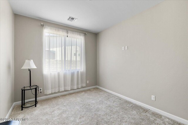 unfurnished room featuring baseboards, visible vents, and carpet floors
