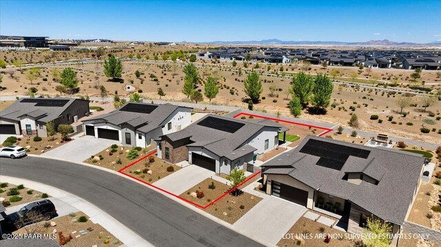 drone / aerial view with a mountain view, a desert view, and a residential view